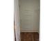 Spacious walk-in closet with wood floor, white door, and wired shelving for organization at 4135 Twenty Grand Dr, Indian Trail, NC 28079