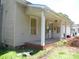 Home's covered porch featuring white support beams, a brick base and a rain gutter at 418 W Cemetery St, Salisbury, NC 28144