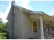 Tan home featuring a brick chimney, rain gutters, and a covered porch area at 418 W Cemetery St, Salisbury, NC 28144