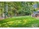 Expansive backyard with playset, lush lawn, and deck; perfect for outdoor fun and relaxation at 4389 Enchantment Cove Ln, Charlotte, NC 28216
