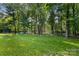 Lush, expansive backyard surrounded by mature trees, providing ample privacy at 4389 Enchantment Cove Ln, Charlotte, NC 28216