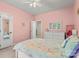 Pink bedroom featuring neutral carpet, a ceiling fan, unicorn themed bedspread, and a white dresser at 4389 Enchantment Cove Ln, Charlotte, NC 28216
