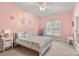 Pink bedroom with neutral carpet, a ceiling fan, and a unicorn themed bedspread at 4389 Enchantment Cove Ln, Charlotte, NC 28216