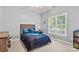Bedroom with neutral carpet, gray walls, ceiling fan, window, and a queen bed with blue comforter at 4389 Enchantment Cove Ln, Charlotte, NC 28216