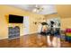 Bright exercise room with a ceiling fan, wood flooring, and plenty of natural light at 4389 Enchantment Cove Ln, Charlotte, NC 28216