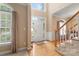 Grand foyer features hardwood floors, elegant staircase, and abundant natural light at 4389 Enchantment Cove Ln, Charlotte, NC 28216