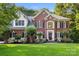 Beautiful two-story brick home with manicured landscaping and a welcoming entrance at 4389 Enchantment Cove Ln, Charlotte, NC 28216