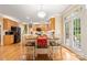 Bright eat-in kitchen boasts wood floors, cabinets, stainless appliances, island, and access to the outdoor space at 4389 Enchantment Cove Ln, Charlotte, NC 28216