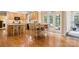 Eat-in kitchen with wood floors and cabinets leads to back deck through french doors at 4389 Enchantment Cove Ln, Charlotte, NC 28216