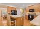 Open kitchen with wood floors, wood cabinets, stainless appliances, and a center island for extra counter space at 4389 Enchantment Cove Ln, Charlotte, NC 28216
