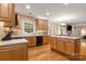 Bright kitchen with wood floors, cabinets, stainless appliances, an island, and open views into living areas at 4389 Enchantment Cove Ln, Charlotte, NC 28216