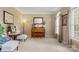 Cozy living room with neutral carpet, natural light, and charming piano at 4389 Enchantment Cove Ln, Charlotte, NC 28216