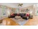 Spacious living room with hardwood floors, ceiling fan, and comfortable seating at 4389 Enchantment Cove Ln, Charlotte, NC 28216