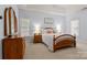 Bright and inviting main bedroom with a tray ceiling, featuring neutral walls and a comfortable bed at 4389 Enchantment Cove Ln, Charlotte, NC 28216