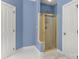 A framed shower enclosure featuring a golden shower head and a glass door at 4389 Enchantment Cove Ln, Charlotte, NC 28216