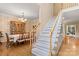 Elegant staircase next to the formal dining room with wood trim and carpeted steps at 4389 Enchantment Cove Ln, Charlotte, NC 28216