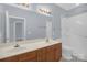Well-lit bathroom featuring a double sink vanity and shower with accessible hand rails at 4467 Antelope Ln, Charlotte, NC 28269