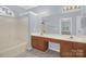 Bright bathroom featuring a double sink vanity and a tub/shower combination, offering comfort at 4467 Antelope Ln, Charlotte, NC 28269