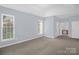 Bright bedroom with large windows, carpet and an ensuite bathroom, offers ample natural light and convenience at 4467 Antelope Ln, Charlotte, NC 28269