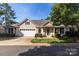 Charming ranch-style home with a two-car garage, lush lawn, mature landscaping, and inviting curb appeal at 4467 Antelope Ln, Charlotte, NC 28269