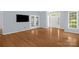 Bright, airy living room with hardwood floors, neutral paint, and a door leading to an outdoor area at 4467 Antelope Ln, Charlotte, NC 28269