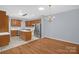 Open-concept living space with hardwood floors connecting the living and dining areas, adjacent to the kitchen at 4467 Antelope Ln, Charlotte, NC 28269