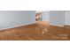 Open-concept living area with hardwood floors, neutral paint, and a doorway leading to the kitchen at 4467 Antelope Ln, Charlotte, NC 28269
