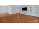 Spacious living room with hardwood floors, neutral walls, and a door leading to an outdoor area at 4467 Antelope Ln, Charlotte, NC 28269