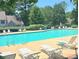 Community swimming pool surrounded by lounge chairs and lush landscaping at 4467 Antelope Ln, Charlotte, NC 28269