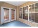 Enclosed sun room with a blue floor and sliding doors to access the yard at 4467 Antelope Ln, Charlotte, NC 28269