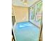 Enclosed sun room with a blue floor, many windows, and tongue-and-groove paneling at 4467 Antelope Ln, Charlotte, NC 28269