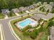 Aerial view of a neighborhood pool, playground, and parking area in a community at 4935 Norman Park Pl, Clover, SC 29710