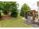 Spacious backyard with a covered patio, grill, and well-maintained lawn, perfect for outdoor entertaining at 4935 Norman Park Pl, Clover, SC 29710