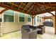 Covered patio with comfortable seating, offering a great space to relax and enjoy the backyard ambiance at 4935 Norman Park Pl, Clover, SC 29710