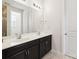 Bathroom with a dual sink vanity featuring a mirror and lighting, with a doorway on the background at 4935 Norman Park Pl, Clover, SC 29710