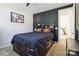 Bedroom featuring a dark accent wall and a large bed with built in bookcase and drawers at 4935 Norman Park Pl, Clover, SC 29710