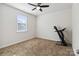 Clean and bright bedroom featuring a ceiling fan, plush carpeting and an elliptical exercise machine at 4935 Norman Park Pl, Clover, SC 29710