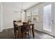 Cozy dining area features a wooden table, hardwood floors, and natural light at 4935 Norman Park Pl, Clover, SC 29710