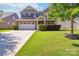 Charming two-story home features a well-manicured lawn, brick accents, and a two-car garage at 4935 Norman Park Pl, Clover, SC 29710