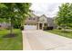 Traditional two-story home featuring a two-car garage, complemented by a lush lawn and mature trees at 4935 Norman Park Pl, Clover, SC 29710