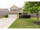 Charming two-story home with brick and siding, attached two-car garage, and well-manicured lawn at 4935 Norman Park Pl, Clover, SC 29710