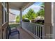 Cozy front porch with white railing and a sitting area, surrounded by lush landscaping at 4935 Norman Park Pl, Clover, SC 29710