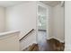 Upstairs hallway leading to rooms with hardwood flooring at 4935 Norman Park Pl, Clover, SC 29710