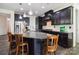 Modern kitchen featuring a large center island, dark cabinets, and granite countertops at 4935 Norman Park Pl, Clover, SC 29710