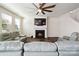 Cozy living room with a fireplace, ceiling fan, and comfortable seating at 4935 Norman Park Pl, Clover, SC 29710