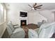 Bright living room features a cozy fireplace, a ceiling fan, and comfortable seating at 4935 Norman Park Pl, Clover, SC 29710