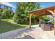 Serene outdoor patio featuring a wooden pergola, ideal for entertaining or relaxing amidst the natural landscape at 4935 Norman Park Pl, Clover, SC 29710
