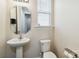 Cozy powder room with a pedestal sink, and a window offering natural light at 4935 Norman Park Pl, Clover, SC 29710