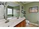 Well-lit bathroom featuring double sinks, modern fixtures, and a large mirror at 5011 Blue Stream Ln, Indian Trail, NC 28079