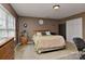 Bedroom with double closet, ceiling fan, light colored carpet and earth tone walls at 5011 Blue Stream Ln, Indian Trail, NC 28079